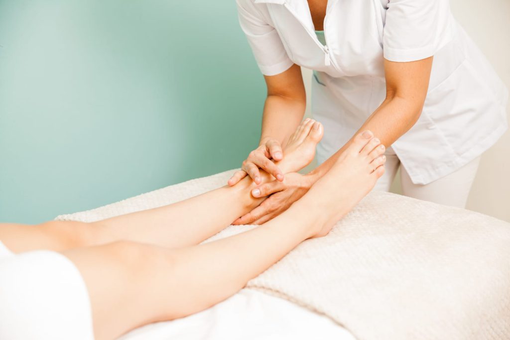 Therapist giving a foot and leg massage